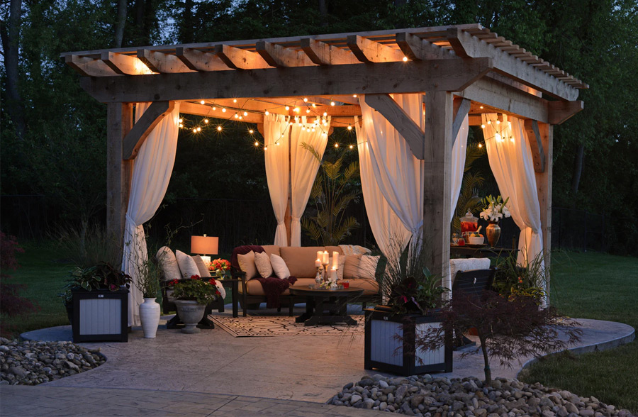 wooden gazebo with lights and white curtains